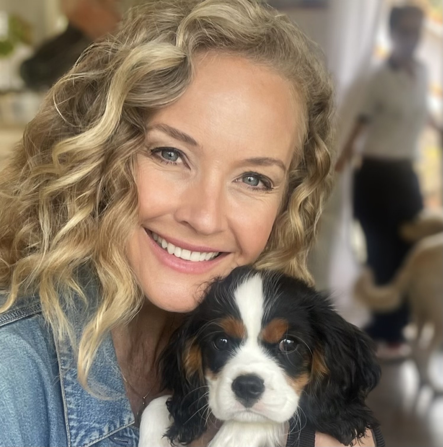 Savannah Miller, MSW, LICSW, LCSW, smiling warmly while holding a small spaniel puppy