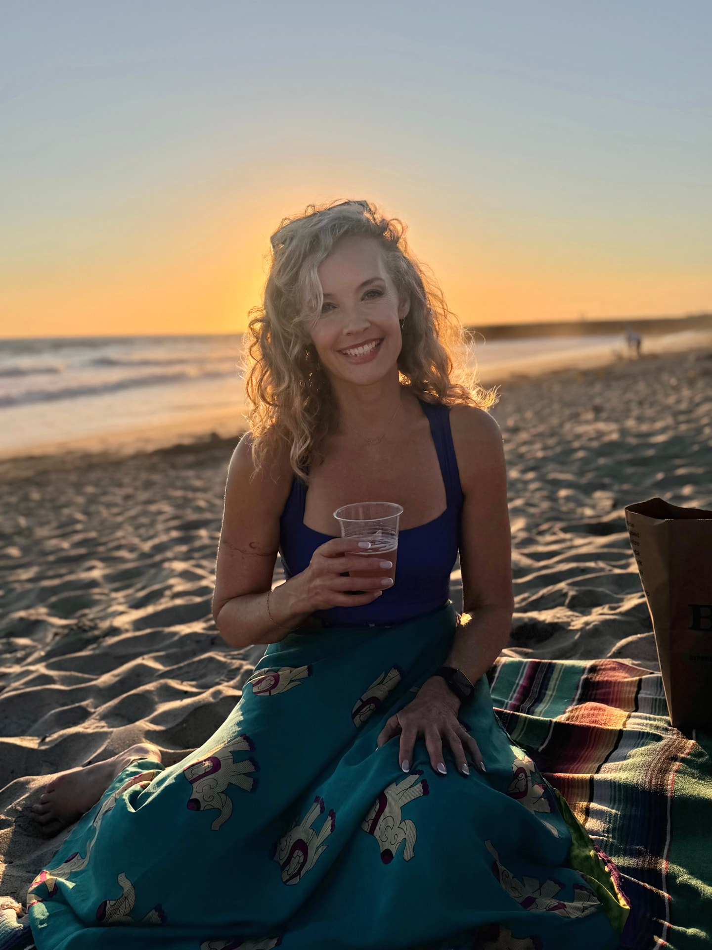 Savannah Miller, MSW, LICSW, LCSW sitting on a California beach at sunset