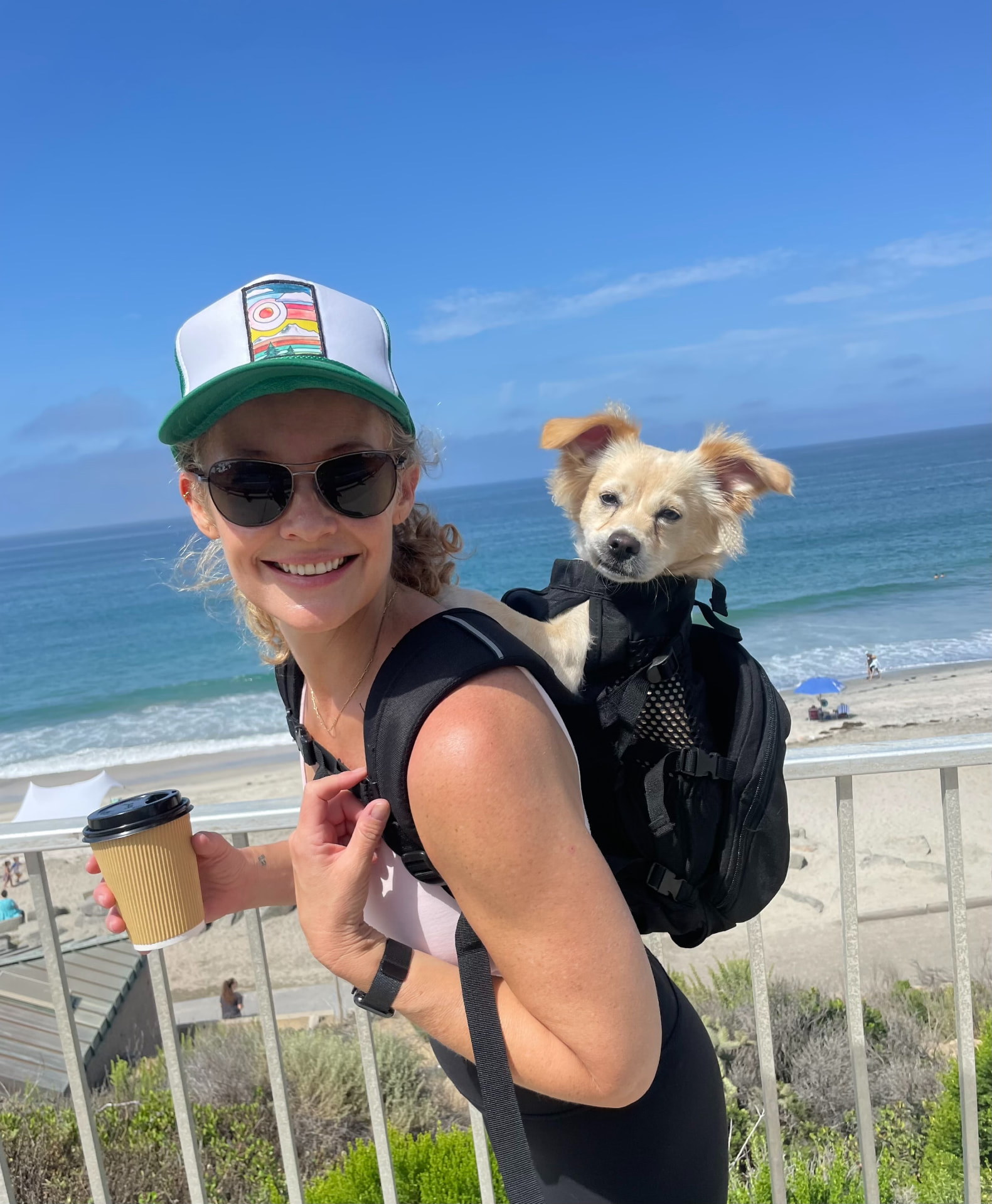 Savannah Miller, MSW, LICSW, LCSW on a coastal overlook in California with her dog in a carrier